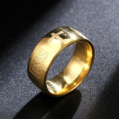 A gold-toned stainless steel ring featuring an engraved cross and the word Jesus.