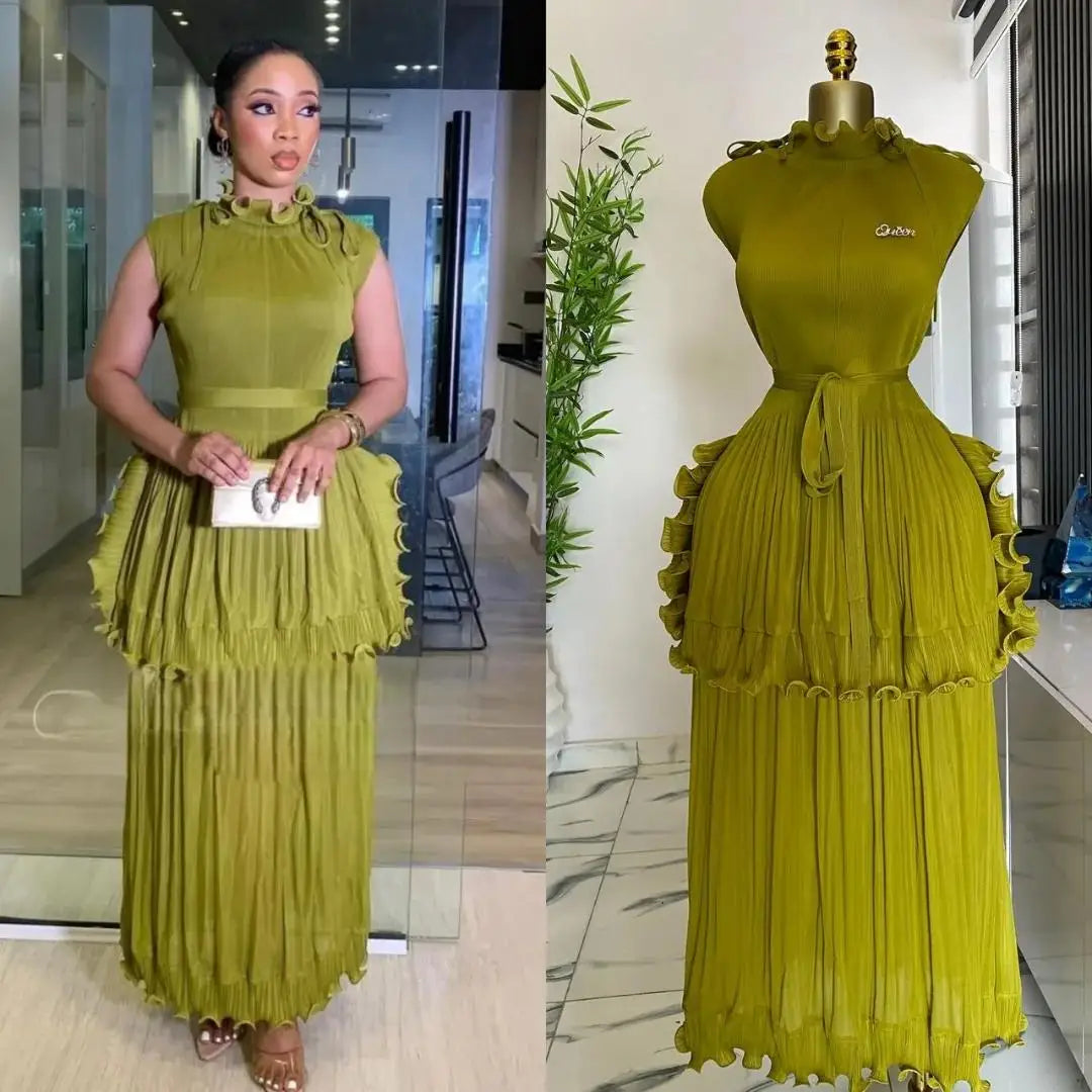 A sleeveless olive green pleated midi dress with a ruffled peplum waist and a matching belt.