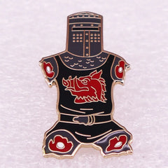 A black and red enamel lapel pin shaped like a knight in armor with a boar emblem on the chest.