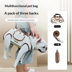 A person carries a small dog in a beige multifunctional pet harness bag with detachable straps.