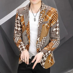 A man wears a slim-fit blazer featuring a brown and white houndstooth and plaid patchwork pattern.