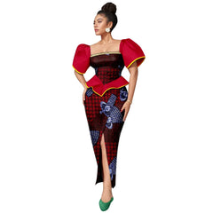 A woman wears an ankle-length Ankara print dress with a square neckline and red puff sleeves.
