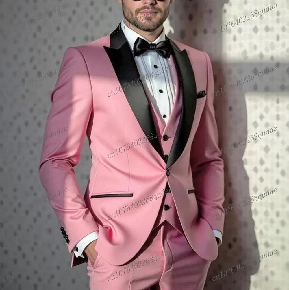 A man wears a three-piece pink suit with a black shawl collar, vest, and bow tie.