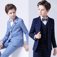Two boys wear formal plaid three-piece suits with blazers, vests, and trousers.