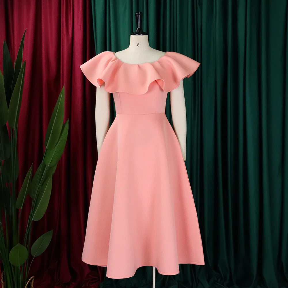 A solid pink mid-calf A-line dress with a round neckline and ruffled butterfly sleeves.