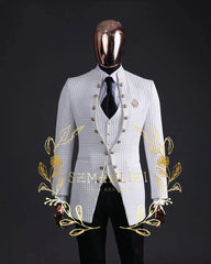 A white floral jacquard three-piece suit with a stand collar and gold buttons on a mannequin.