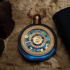 A circular blue perfume bottle with a gold Viking helmet cap and a central number three emblem.