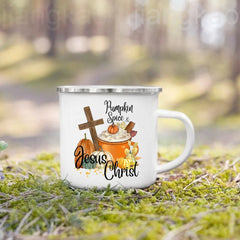A white enamel camping mug featuring a fall-themed graphic of a cross, pumpkins, and coffee.
