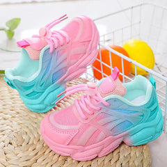 A pair of girls' gradient pink and blue mesh sneakers with a platform sole and toggle laces.