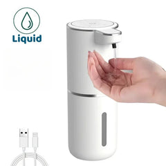 A white automatic liquid soap dispenser with a hand underneath and a USB charging cable.