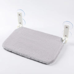 A grey plush cat hammock with white support brackets and suction cups for window mounting.