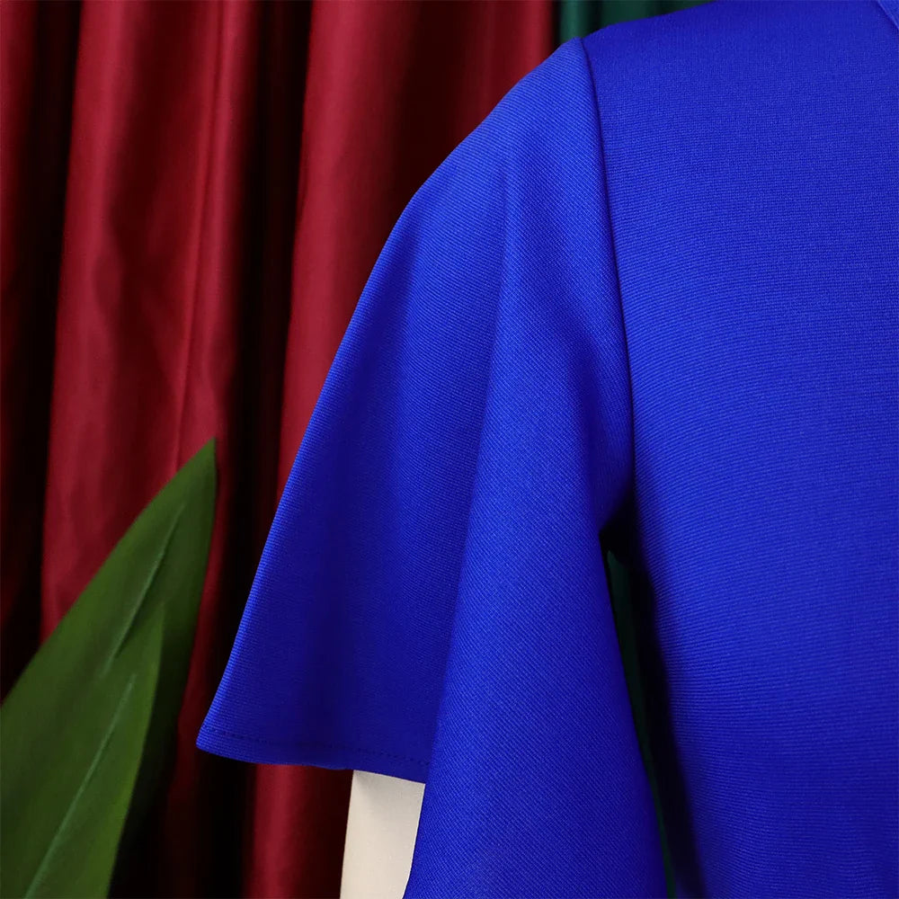 A close-up view of the blue butterfly sleeve on a solid-colored dress.