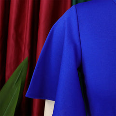 A close-up view of the blue butterfly sleeve on a solid-colored dress.