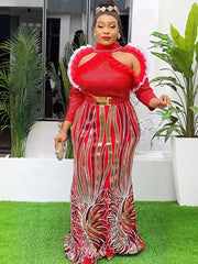 A woman wears a red sequined floor-length gown with puff sleeves and a gold waist belt.