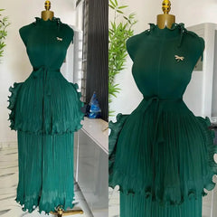 A sleeveless emerald green pleated midi dress with a ruffled peplum waist and a matching belt.