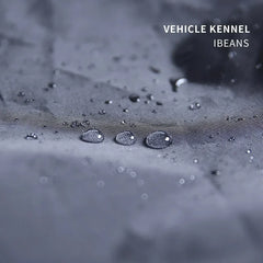 A close-up view of water droplets beading on the grey, water-resistant nylon fabric of a pet kennel.