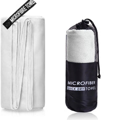 A white microfiber towel shown folded next to its black mesh carrying bag.