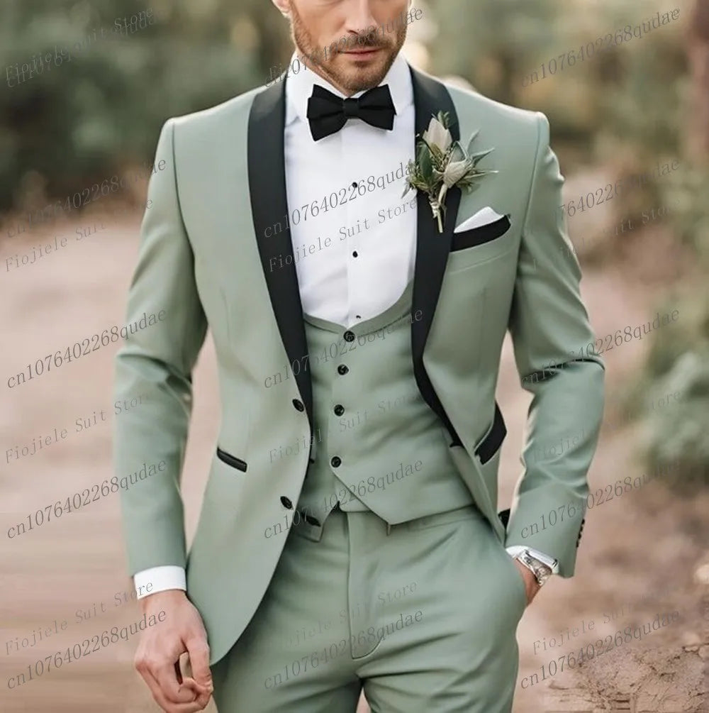 A sage green three-piece suit with a black shawl collar, black bow tie, and white pocket square.