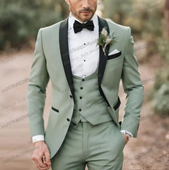 A sage green three-piece suit with a black shawl collar, black bow tie, and white pocket square.