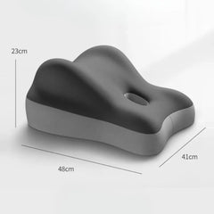 A grey ergonomic memory foam pillow with a central cutout and wedge-shaped design.