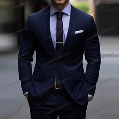 A man wears a dark navy blue two-piece formal suit with a light blue shirt and a patterned tie.