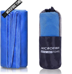 A blue microfiber sports towel shown unfolded next to its matching mesh carrying pouch.