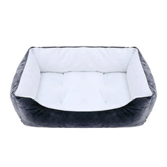 A rectangular pet bed with a dark grey exterior and a soft white plush interior.