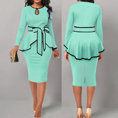 A mint green two-piece set featuring a long-sleeved peplum top with black trim and a matching skirt.