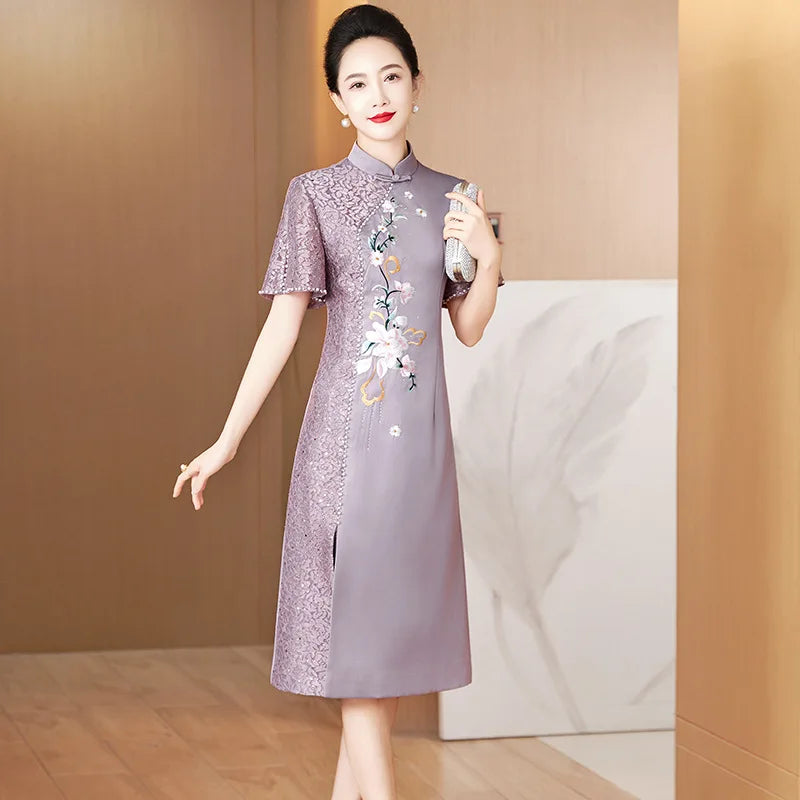 A woman wears a purple satin cheongsam with lace detailing, short sleeves, and floral embroidery.