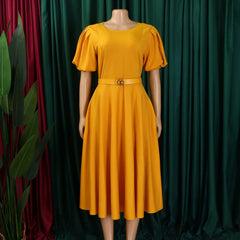 A mustard yellow midi dress with short puff sleeves, a round neckline, and a matching waist belt.