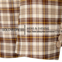 A close-up of a beige and brown checkered blazer sleeve with three buttons on the cuff.