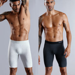 Two men wearing long-leg cotton boxer shorts in light gray and dark gray.