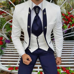 A three-piece men's formal suit featuring a white patterned jacket, white vest, and blue trousers.