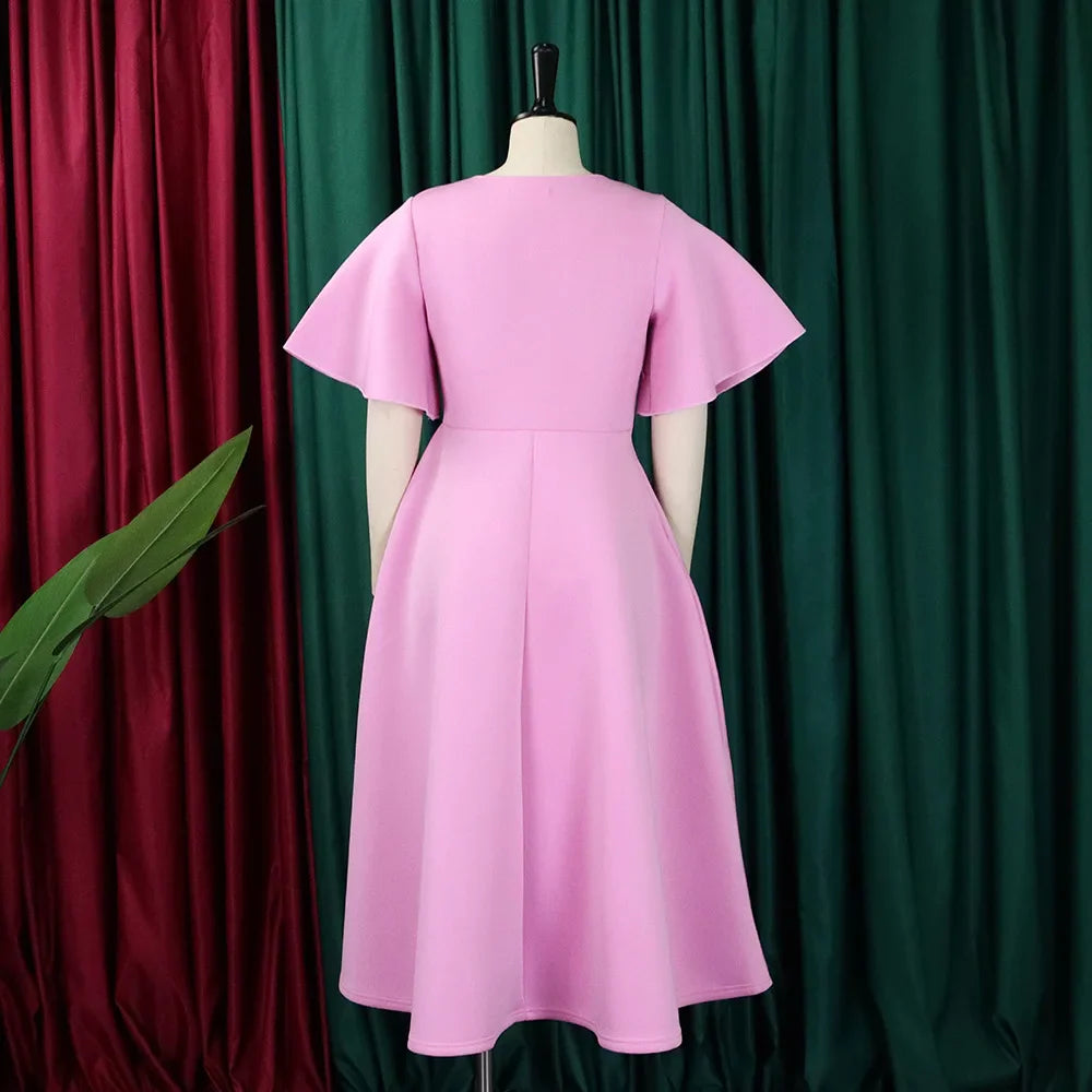A pink mid-calf A-line dress with a V-neck and butterfly sleeves on a mannequin.