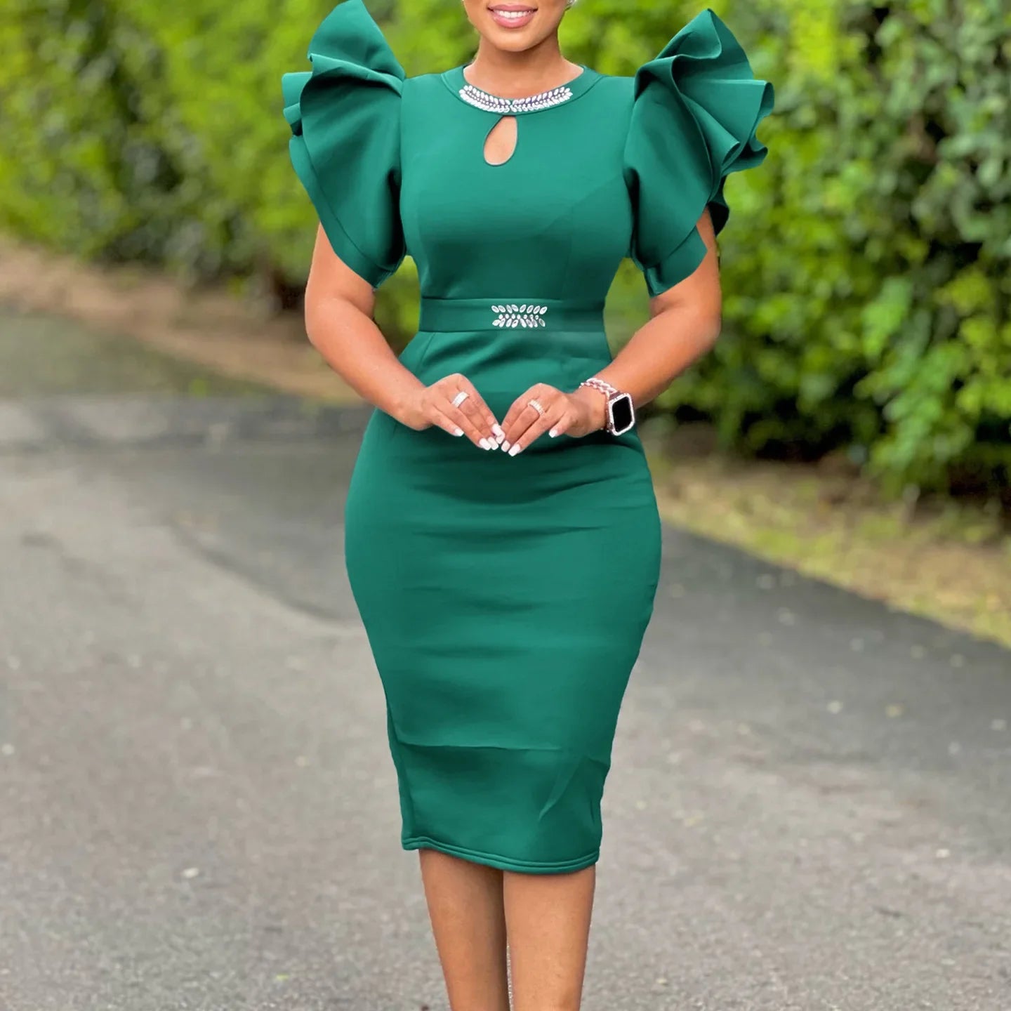 A dark green midi bodycon dress with ruffled sleeves, a keyhole neckline, and rhinestone accents.
