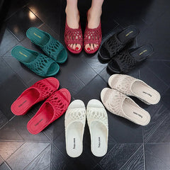 A collection of women's wedge slippers with hollow-out peep toes in various colors.