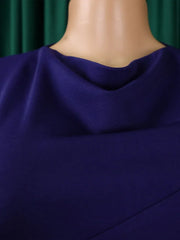 A close-up of a solid purple dress featuring a draped cowl neckline.