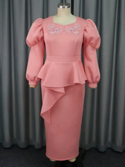 A pink ankle-length dress with puff sleeves, a V-neckline, floral appliques, and a peplum waist.