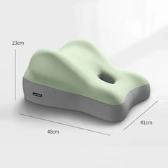 A light green and grey ergonomic memory foam pillow with a central cutout and dimensions labeled.