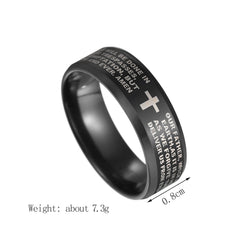 A black stainless steel ring featuring an engraved cross and Bible prayer text.
