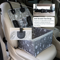 A grey dog car booster seat with a bone and paw print pattern installed on a vehicle seat.