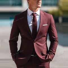 A man wears a formal brown two-piece suit with a white shirt and a matching brown tie.
