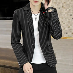A slim-fit black blazer with white vertical stripes, featuring a single button and lapel pin.