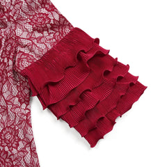 A close-up of a red lace sleeve featuring three tiers of pleated, ruffled cuffs.