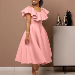 A woman wears a pink mid-calf A-line dress with a round neckline and ruffled butterfly sleeves.