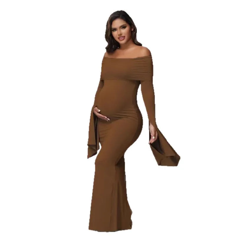 A pregnant woman wears a solid brown off-shoulder long-sleeve mermaid maternity dress.