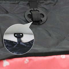 A close-up shows a black plastic anchor used to secure a quilted pet car seat cover.