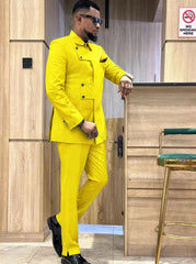 A man wearing a bright yellow slim-fit suit with a unique asymmetrical button-down jacket.
