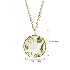 A gold-tone pendant necklace featuring a circular charm with mother-of-pearl and religious symbols.