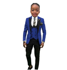 A boy wears a three-piece formal suit featuring a blue blazer with black lapels, a matching vest, and black trousers.